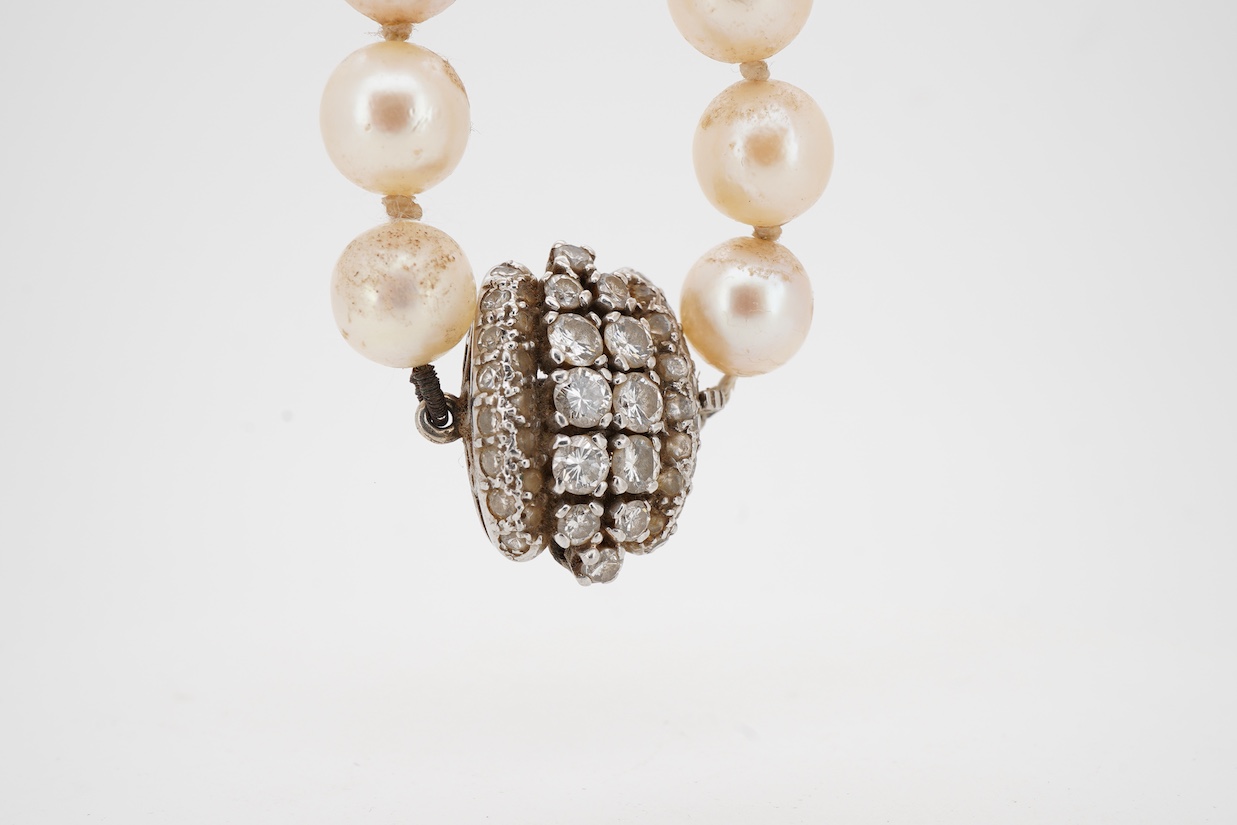 A single strand cultured pearl necklace, with white metal clasp set with two rows of graduated diamonds with a diamond chip border, 72cm.